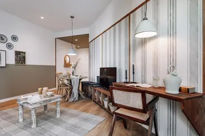a kitchen with white cabinets and a hallway with a table at Montoro - 1 bedroom in Eixample Esquerra in Barcelona