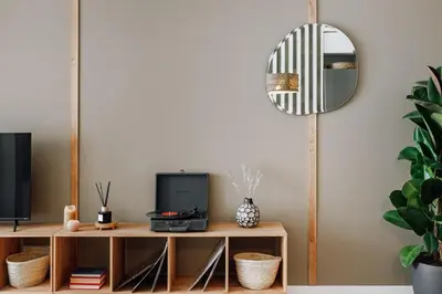 a mirror hanging on a wall in a living room at Aldeire - 2 bedrooms, office in Eixample Esquerra in Barcelona