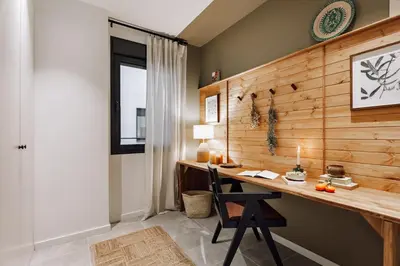 a living room with a couch and a tv at Aldeire - 2 bedrooms, office in Eixample Esquerra in Barcelona