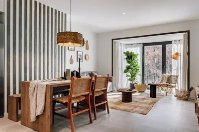a kitchen with white cabinets and a stainless steel refrigerator at Aldeire - 2 bedrooms, office in Eixample Esquerra in Barcelona