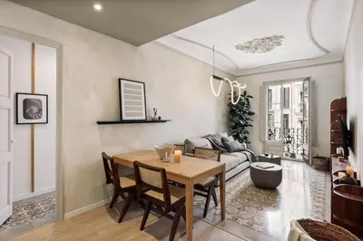 a living room with a couch and a tv at Lluna - 2 Bedrooms and office in Gracia in Barcelona