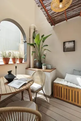 a kitchen with white cabinets and a wooden table at Aleu - 2 bedrooms and balcony in Sagrada Família in Barcelona