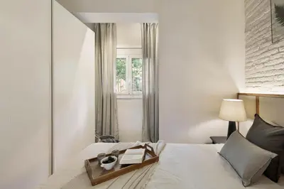 a bedroom with a bed with a mirror at Aleu - 2 bedrooms and balcony in Sagrada Família in Barcelona