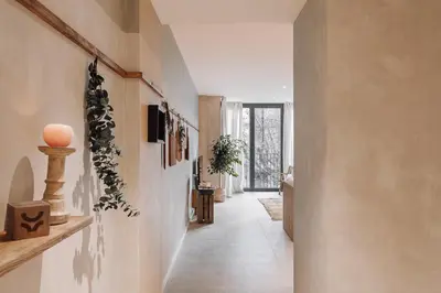 a living room with a wall with paintings on it at Nivar - 2 bedrooms in Eixample Esquerra in Barcelona