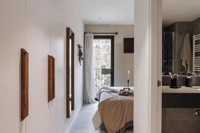 a bedroom with a large bed with a wooden headboard at Nivar - 2 bedrooms in Eixample Esquerra in Barcelona