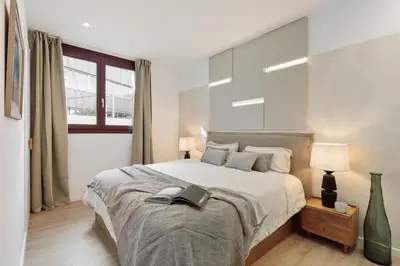 a bed with two lamps and a tablet on it at Velia - 2 bedrooms and terrace in Ciutat Vella in Barcelona