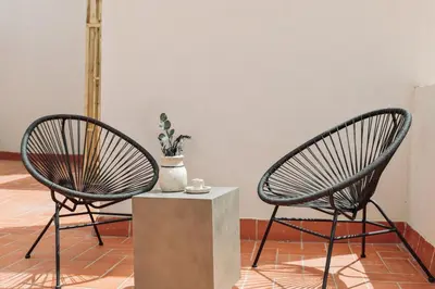 a patio with a pergola and a table and chairs at Velia - 2 bedrooms and terrace in Ciutat Vella in Barcelona
