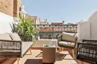 a patio with two chairs and a table on a balcony at Neu - 2 bedrooms and terrace in Eixample Esquerra in Barcelona