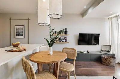 a kitchen with wooden cabinets and a sink at Neu - 2 bedrooms and terrace in Eixample Esquerra in Barcelona