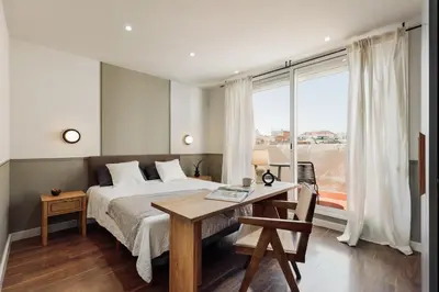 a kitchen with a black refrigerator in a room at Neu - 2 bedrooms and terrace in Eixample Esquerra in Barcelona