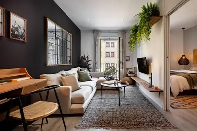 a table with a plant in a vase on it at Quena - 2 bedrooms and balcony in Eixample Dreta in Barcelona