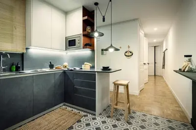 a living room with a couch and a large window at Akita - 2 bedrooms, terrace in Eixample Esquerra in Barcelona