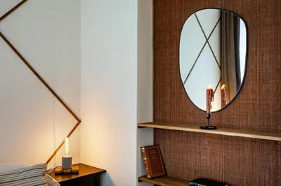 a bedroom with a mirror on a brick wall at Siwa - 2 bedrooms in Eixample Dreta in Barcelona