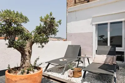 a rooftop patio with furniture and a view of the city at Fuji - 2 bedrooms and terrace in Eixample Esquerra in Barcelona