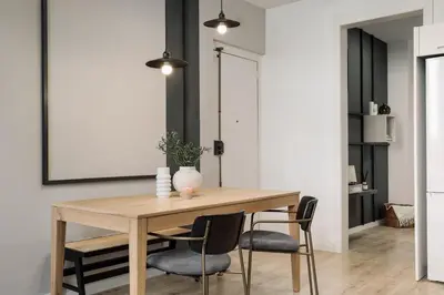 a dining room with a table and chairs and a television at Espriu - 2 bedrooms and balcony in Sant Antoni in Barcelona
