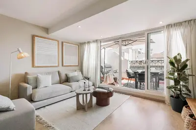 a white bedroom with a large bed and a window at Ascea - 2 bedroom and terrace in Eixample Esquerra in Barcelona