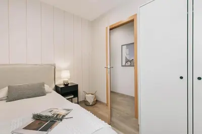a bedroom with a bed and a door to a room at Ascea - 2 bedroom and terrace in Eixample Esquerra in Barcelona