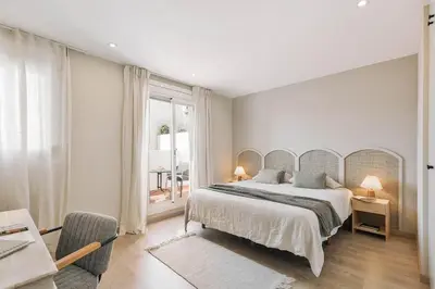 a kitchen with a table and chairs and a refrigerator at Ascea - 2 bedroom and terrace in Eixample Esquerra in Barcelona