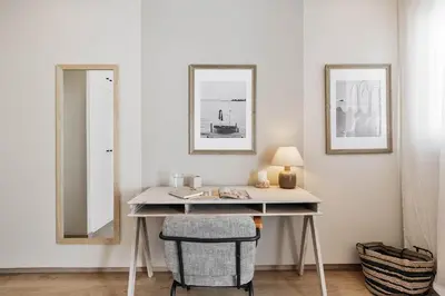 a living room with a couch and a large window at Ascea - 2 bedroom and terrace in Eixample Esquerra in Barcelona