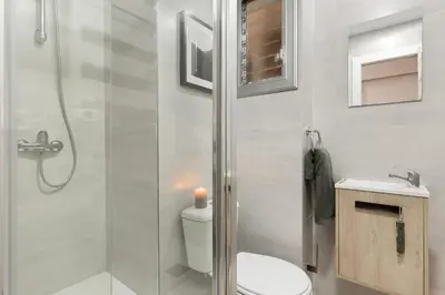 a desk with a chair and a lamp and pictures on the wall at NIVE - 3 bedrooms apartment in Sant Gervasi in Barcelona