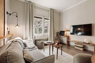 a living room with a couch and a tv at Cadi - 1 bedroom apartment in Sant Gervasi in Barcelona