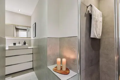 a bathroom with a shower with two candles on a counter at Cadi - 1 bedroom apartment in Sant Gervasi in Barcelona