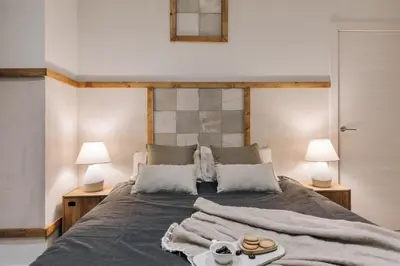 a bedroom with white walls and a large bed at Giralda - 3 bedrooms in Sagrada Família in Barcelona