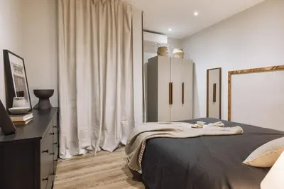 a bed with two lamps and a tray of food on it at Giralda - 3 bedrooms in Sagrada Família in Barcelona