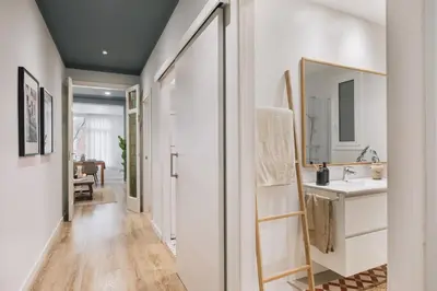 a bedroom with a bed and a desk with a laptop at Giralda - 3 bedrooms in Sagrada Família in Barcelona