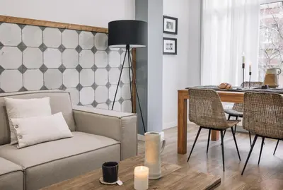 a living room with a chair and a plant at Giralda - 3 bedrooms in Sagrada Família in Barcelona