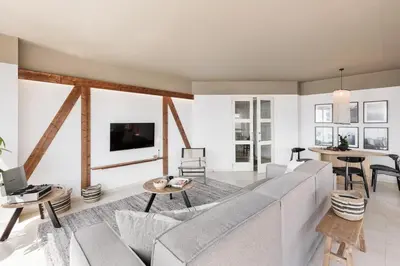 a living room with a couch and a table at Pavots - 3 bedrooms, pool and gym in Poblenou in Barcelona