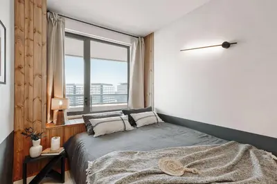 a white bedroom with a large bed with a table on it at Pavots - 3 bedrooms, pool and gym in Poblenou in Barcelona