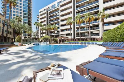 a tennis court in a city with tall buildings at Pavots - 3 bedrooms, pool and gym in Poblenou in Barcelona