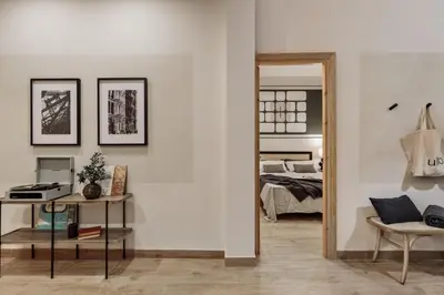 a bedroom with a large bed and a mirror at Krasner - 3 bedrooms in Eixample Dreta in Barcelona