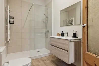 a bedroom with a bed and a table and a piano at Krasner - 3 bedrooms in Eixample Dreta in Barcelona