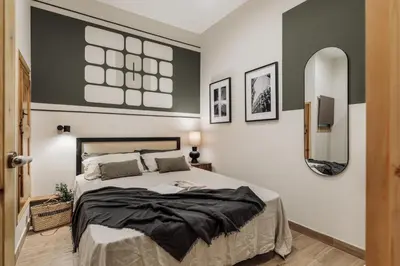 a bedroom with a bed and a table in it at Krasner - 3 bedrooms in Eixample Dreta in Barcelona