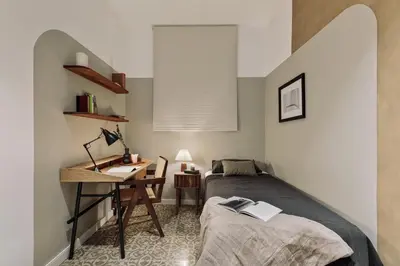 a kitchen with black and white cabinets and a table at Gava - 3 bedrooms and terrace in Sagrada Família in Barcelona