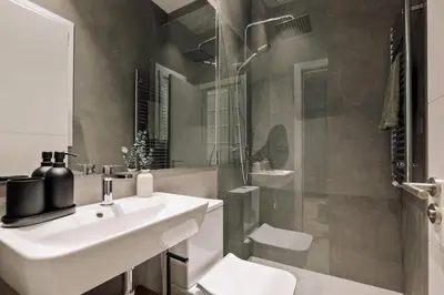 a white bathroom with a sink and a shower at Gava - 3 bedrooms and terrace in Sagrada Família in Barcelona