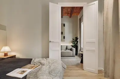 a kitchen and dining room with a wooden table at Gava - 3 bedrooms and terrace in Sagrada Família in Barcelona