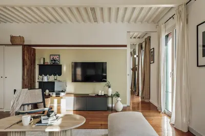 a desk with a lamp and a table with chairs at Taksim - 2 bedrooms and balcony in La Barceloneta in Barcelona
