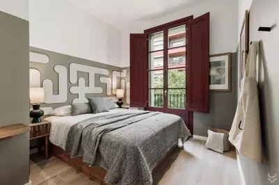 a living room with a desk and a tv on a wall at Aire - 1 bedroom and balcony in Sant Antoni in Barcelona
