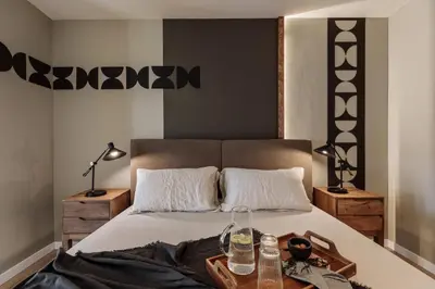 a bedroom with a large bed with a black blanket at Aymara - 5 bedrooms and terrace in Pedralbes in Barcelona