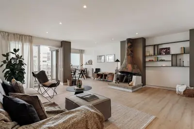 a living room with a couch and a fireplace at Aymara - 5 bedrooms and terrace in Pedralbes in Barcelona