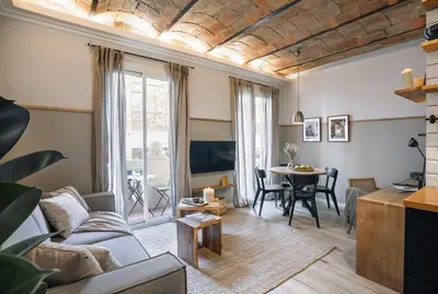 a living room with a couch and a table at Senes - 2 bedrooms in Eixample Esquerra in Barcelona