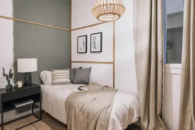 a kitchen with a stove and a living room at Senes - 2 bedrooms in Eixample Esquerra in Barcelona