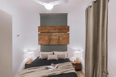 a living room with a couch and a large window at Senes - 2 bedrooms in Eixample Esquerra in Barcelona