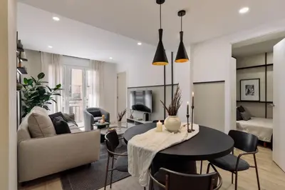 a living room with a couch and a table at Basquiat - 2 bedrooms and office in Sant Gervasi in Barcelona