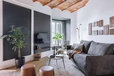 a bedroom with a large bed with a wooden ceiling at Feliu - 2 bedrooms in Eixample Dreta in Barcelona