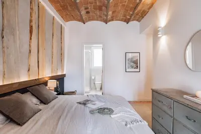 a dining room with a wooden table and chairs at Feliu - 2 bedrooms in Eixample Dreta in Barcelona