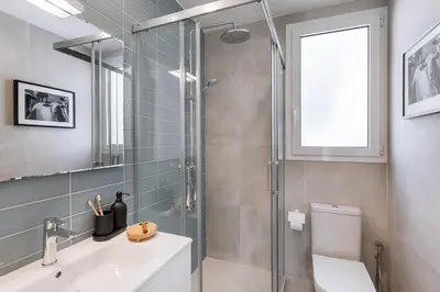 a living room with a couch and a table at Feliu - 2 bedrooms in Eixample Dreta in Barcelona